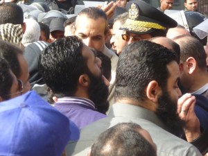 Next to the man in the police cap is Ezzat al-Salamony. He is a leader with the Islamic Group, not the Salafi-Jihadis, and worked to restrain the crowd. He later gave a rousing speech against the French, though, calling for jihad in the lands of the infidels.
