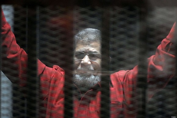 Former President Mohamed Morsi, wearing the red uniform of a prisoner sentenced to death